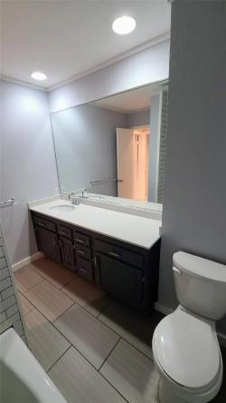 2409 Leon Street, Unit 301 Austin, TX 78705 - Photo 8 of 10 a bathroom with a toilet sink and mirror