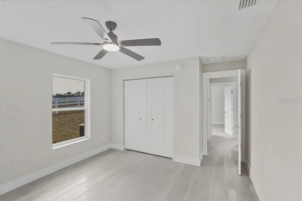 a kitchen with white cabinets and sink