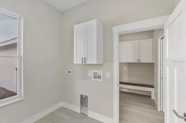 a room with wooden floor and cabinets