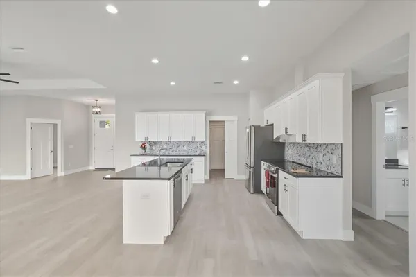 a kitchen with stainless steel appliances granite countertop a stove and a sink