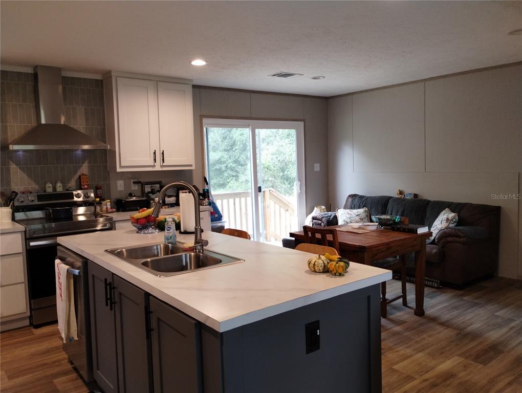 1826 Southeast 44th Place Bushnell, FL 33513 - Photo 15 of 29 a kitchen with a sink a stove and a refrigerator