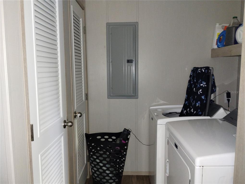 1826 Southeast 44th Place Bushnell, FL 33513 - Photo 20 of 29 a bathroom with a sink and a refrigerator