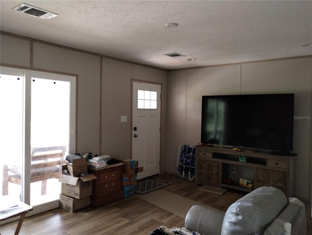 1826 Southeast 44th Place Bushnell, FL 33513 - Photo 23 of 29 a living room with furniture and a flat screen tv