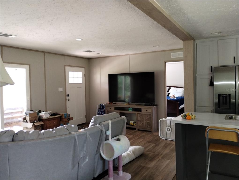 1826 Southeast 44th Place Bushnell, FL 33513 - Photo 24 of 29 a living room with furniture and a flat screen tv
