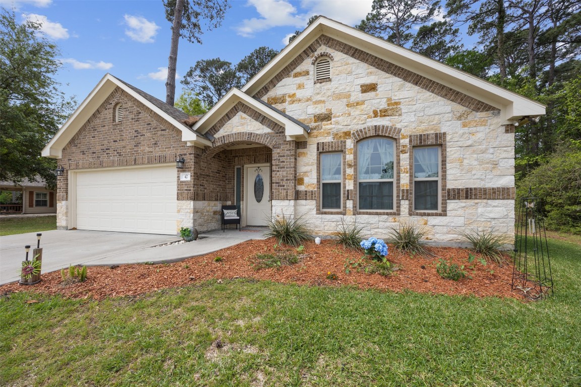 42 Trail Lake Trinity, TX 75862 - Photo 2 of 50 a front view of a house with garden
