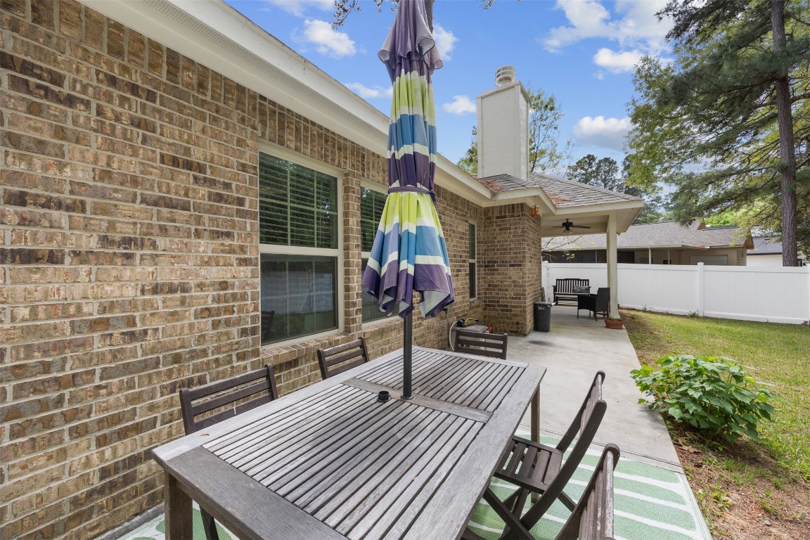 42 Trail Lake Trinity, TX 75862 - Photo 27 of 50 a view of a patio with couches table and chairs with wooden floor and fence