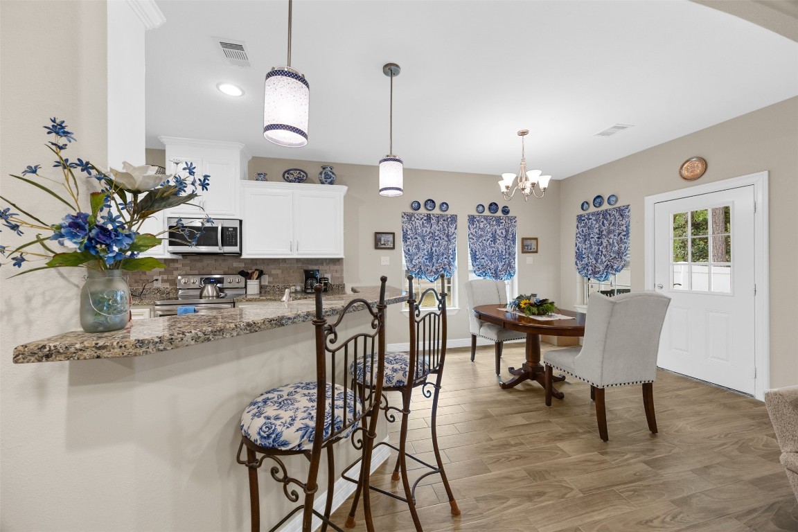 42 Trail Lake Trinity, TX 75862 - Photo 9 of 50 a dining room filled chandelier and wooden floor