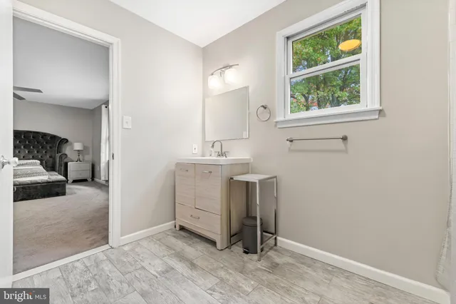 a view of a hallway with a sink and a window