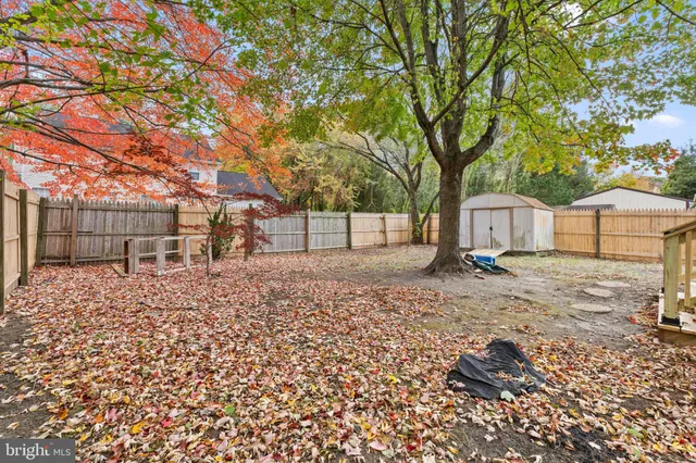 a backyard of a house with barbeque oven