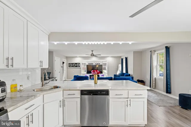 a kitchen with counter top space a sink and cabinets