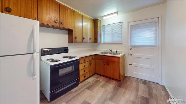 a kitchen with granite countertop a sink and a stove top oven