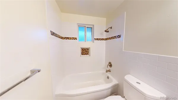 a bathroom with a toilet and a bathtub