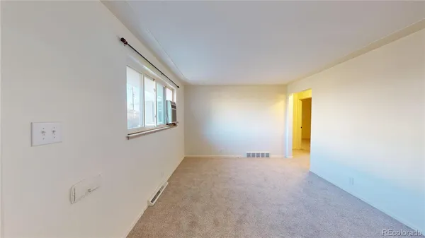 a view of an empty room with a window