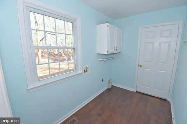 a view of an entryway with wooden floor