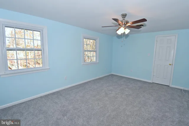 a room with a wooden floor and a fireplace