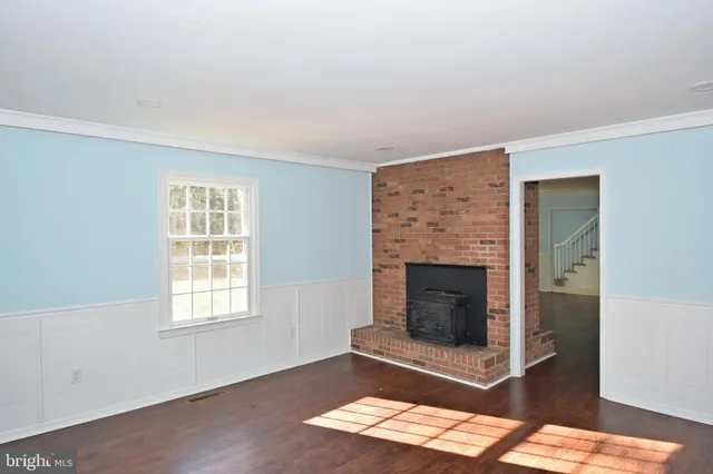 a kitchen with granite countertop white cabinets and refrigerator