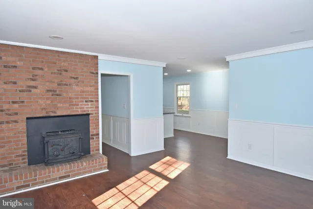 an entryway with wooden floor and window