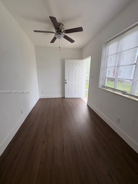 2052 Southwest 7th Street, Unit 4 Miami, FL 33135 - Photo 5 of 10 an empty room with wooden floor fan and windows