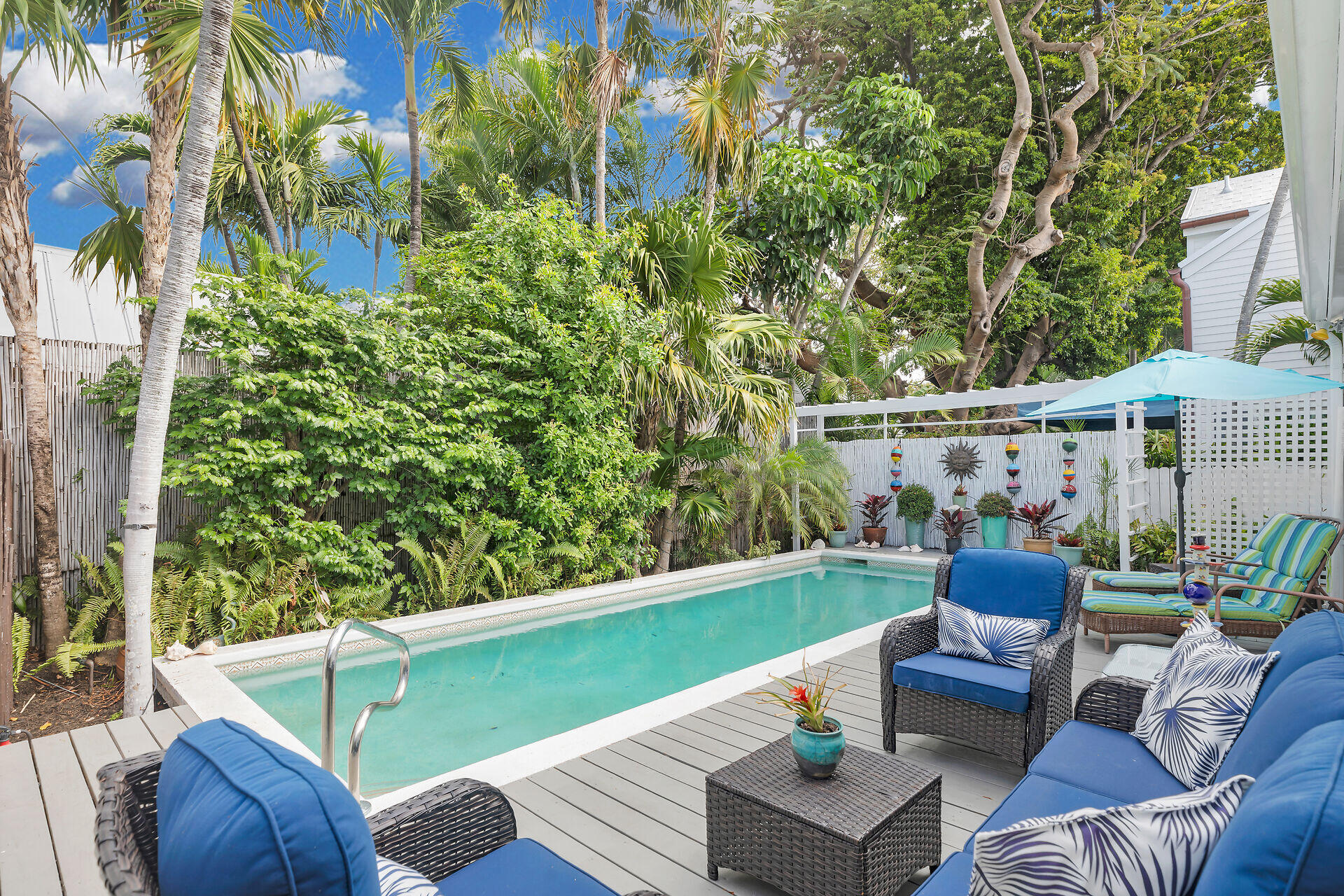 1109 Stump Lane Key West, FL 33040 - Photo 25 of 46 a view of a patio with couches table and chairs and potted plants
