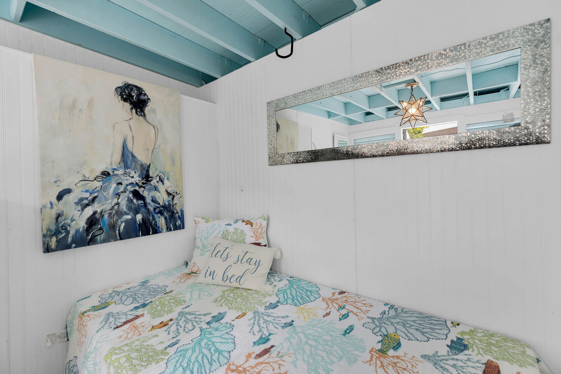1109 Stump Lane Key West, FL 33040 - Photo 32 of 46 a bed sitting in a bedroom next to a window and a wooden floor