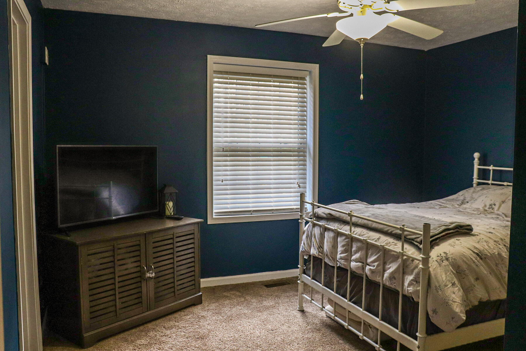 1008 Dusty Rock Road Northwest Riner, VA 24149 - Photo 23 of 28 a bedroom with a bed and a flat tv screen