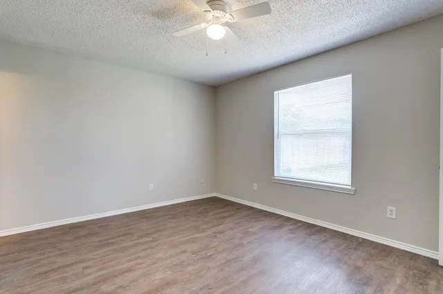 a bathroom with a granite countertop sink a toilet and a bathtub