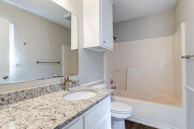 a view of a backyard with wooden fence