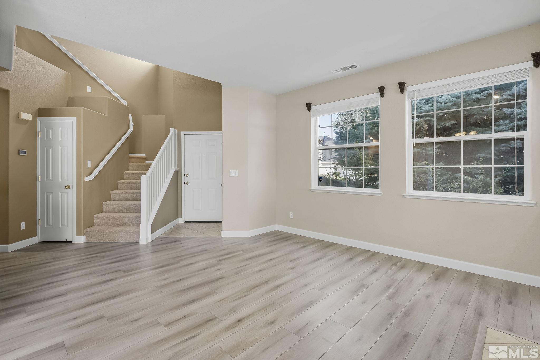 2150 Soldier Pass Court Reno, NV 89523 - Photo 8 of 38 a view of an empty room with wooden floor and a window