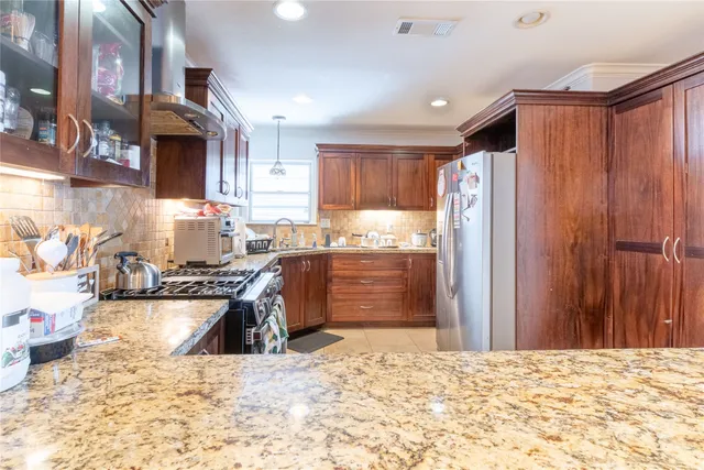 a view of a dining room with furniture and a chandelier fan
