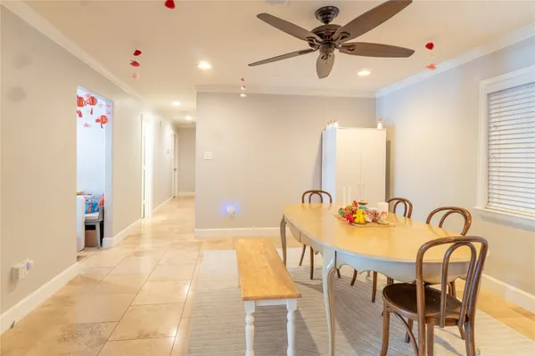 a dining room with a wooden table and chairs