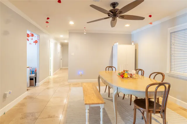 a dining room with a wooden table and chairs