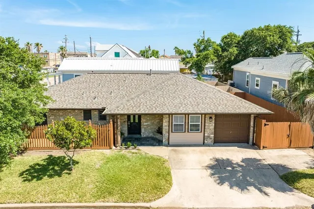 a front view of a house with a garden and potted plants