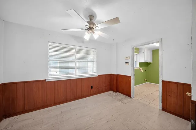a view of an empty room with window and cabinet