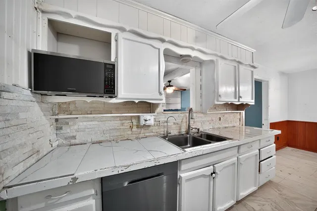a kitchen with a sink and a stove top oven