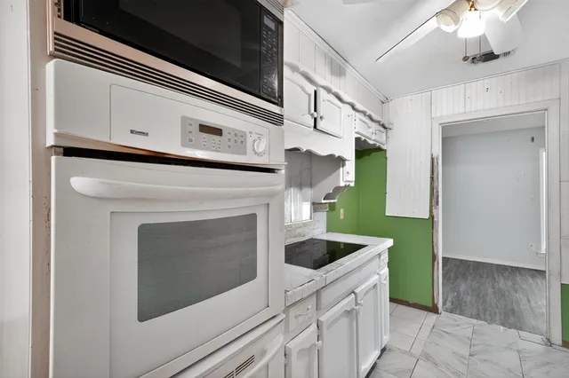 a kitchen with granite countertop a sink and a stove
