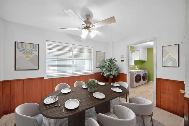 a view of a dining room and kitchen with furniture wooden floor and a chandelier
