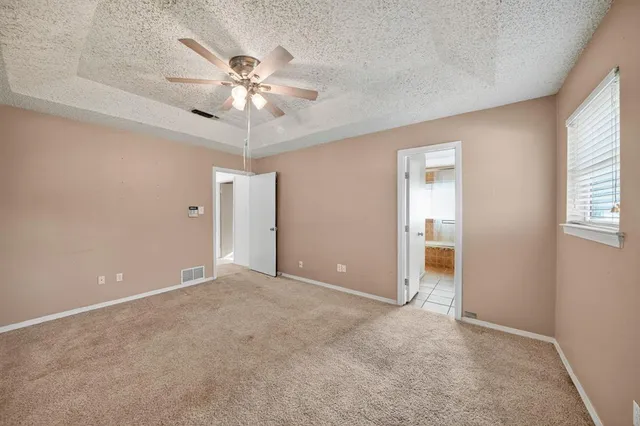 an empty room and chandelier fan