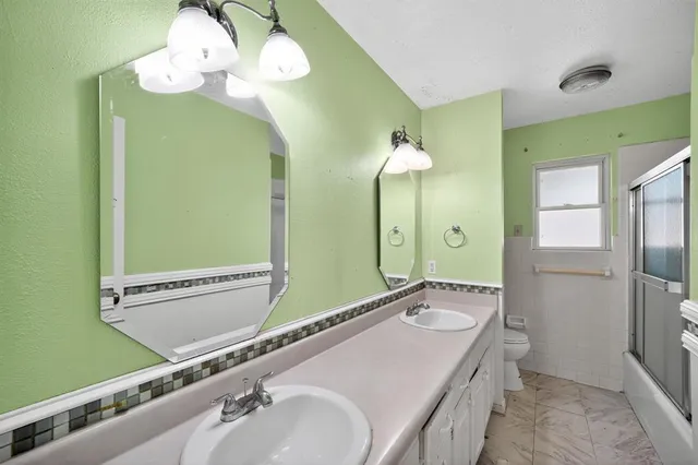 a bathroom with a double vanity sink and a mirror