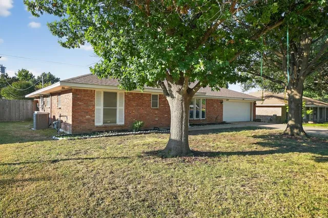 a house that has a tree in front of it