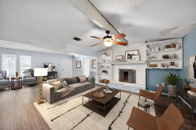 a living room with furniture a fireplace and a flat screen tv