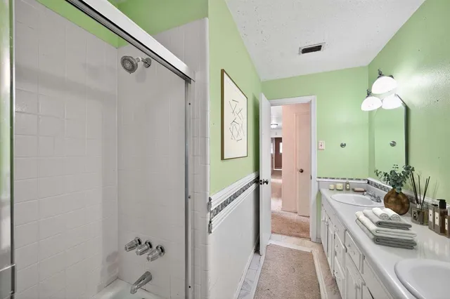 a bathroom with a sink a mirror and a shower
