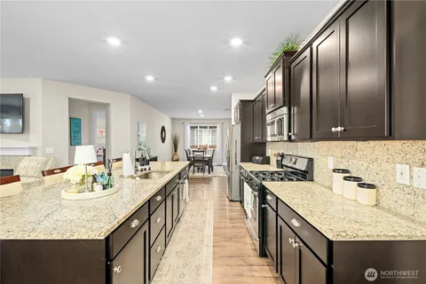 a kitchen with stainless steel appliances granite countertop counter space a sink stove and cabinets