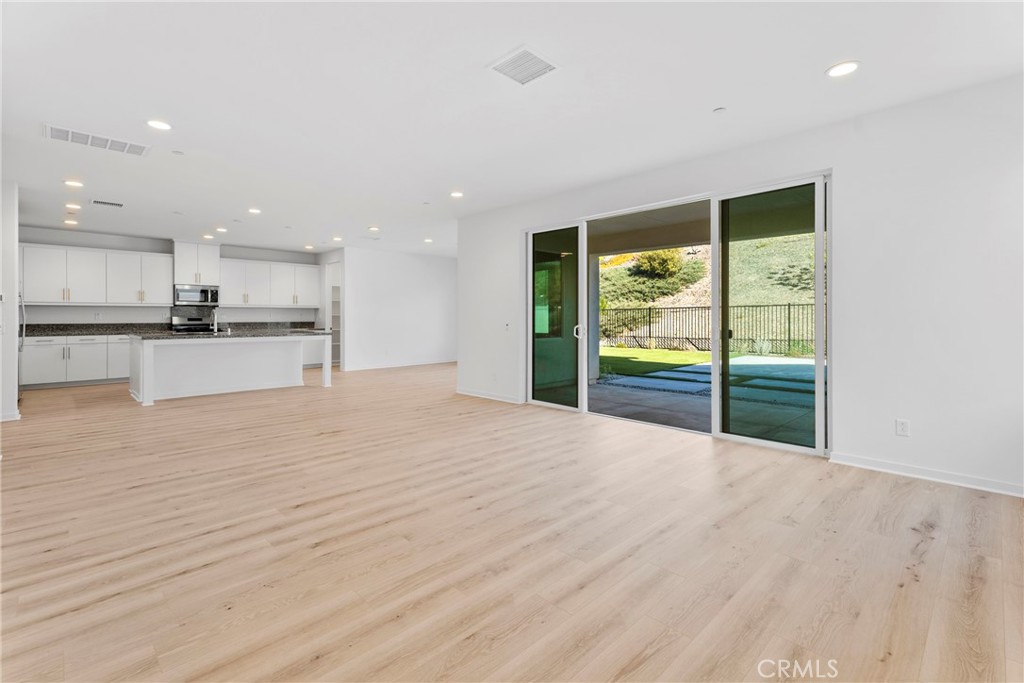 18121 Outlook Way Saugus, CA 91350 - Photo 11 of 59 a view of an empty room with window and wooden floor