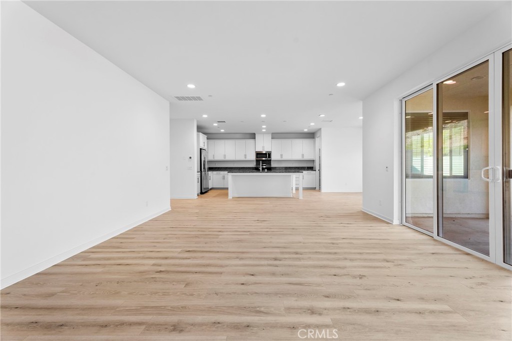 18121 Outlook Way Saugus, CA 91350 - Photo 12 of 59 a large white kitchen with kitchen island a sink stainless steel appliances and cabinets