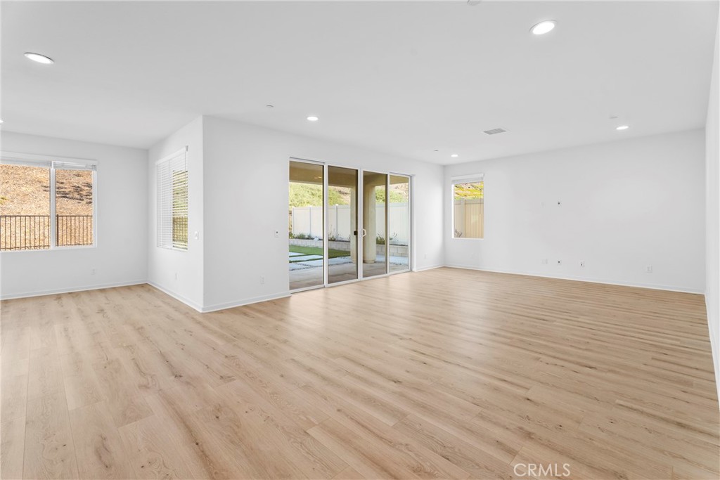 18121 Outlook Way Saugus, CA 91350 - Photo 14 of 59 an empty room with wooden floor and windows