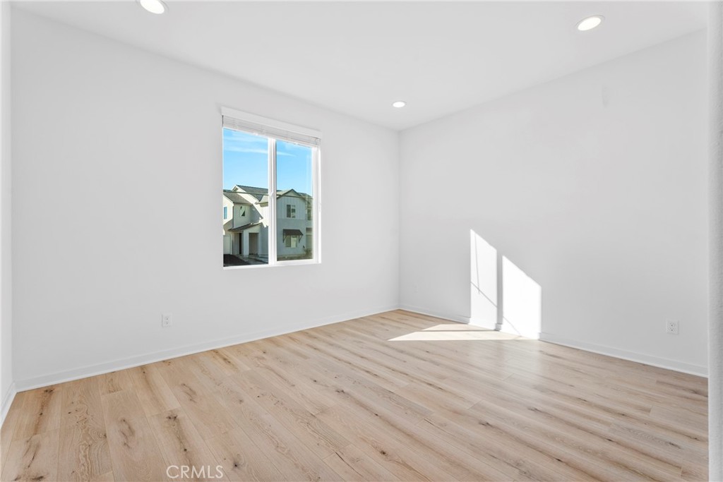 18121 Outlook Way Saugus, CA 91350 - Photo 15 of 59 an empty room with wooden floor and windows
