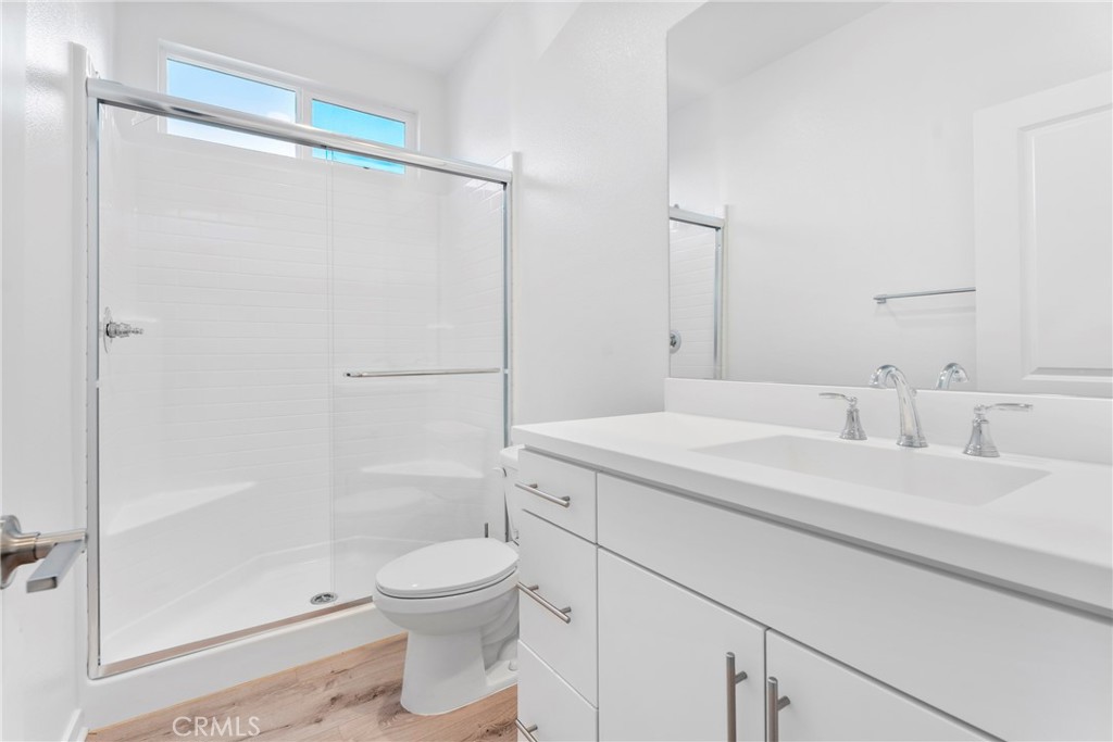 18121 Outlook Way Saugus, CA 91350 - Photo 17 of 59 a bathroom with a granite countertop sink a toilet and shower