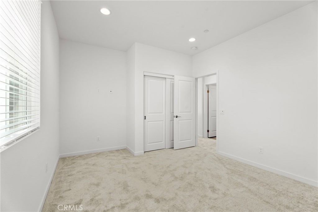 18121 Outlook Way Saugus, CA 91350 - Photo 26 of 59 an empty room with windows and closet