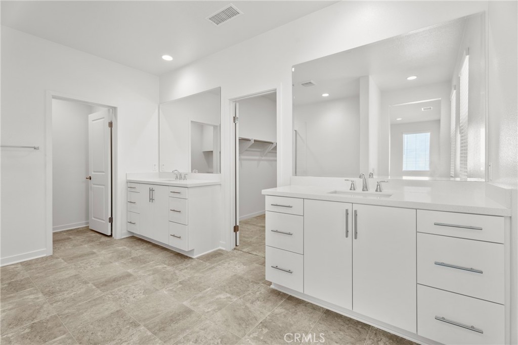 18121 Outlook Way Saugus, CA 91350 - Photo 31 of 59 a bathroom with a double vanity sink and mirror