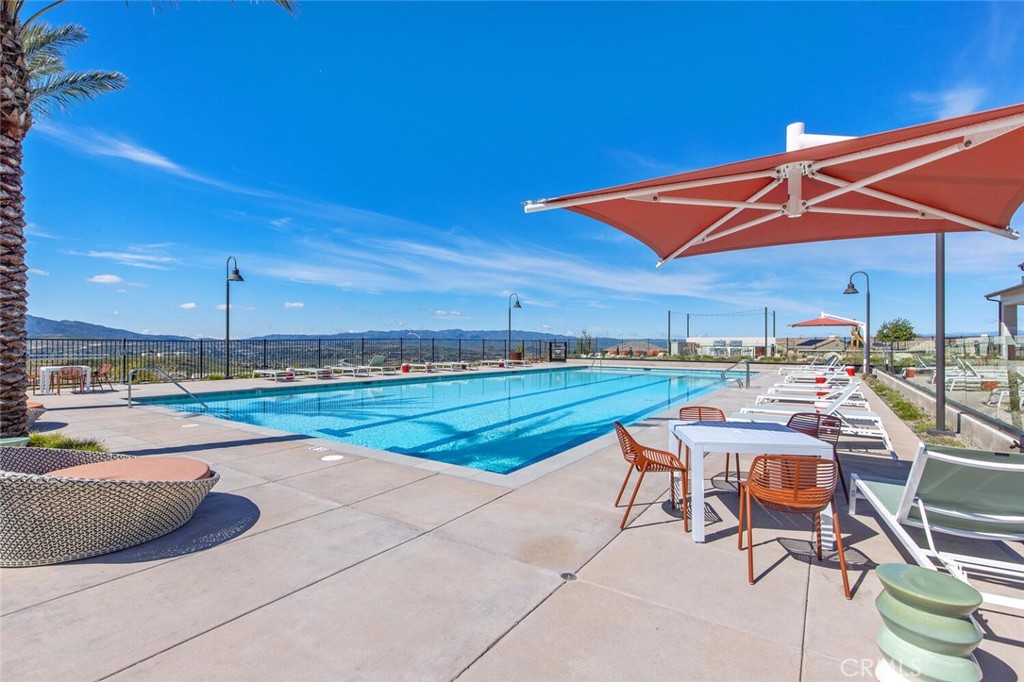 18121 Outlook Way Saugus, CA 91350 - Photo 57 of 59 a patio with a table and chairs under an umbrella